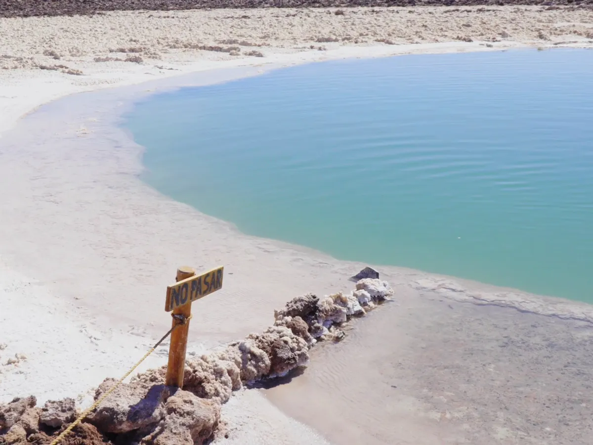 Laguna turquesa entre costras de sal en Baltinache